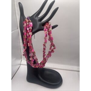 Multi-strand necklace featuring pink shell beads in various shades. 16"